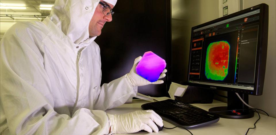 Quality-inspecting a wafer using photoluminescence technology. Laboratory in Leuven, Belgium.
